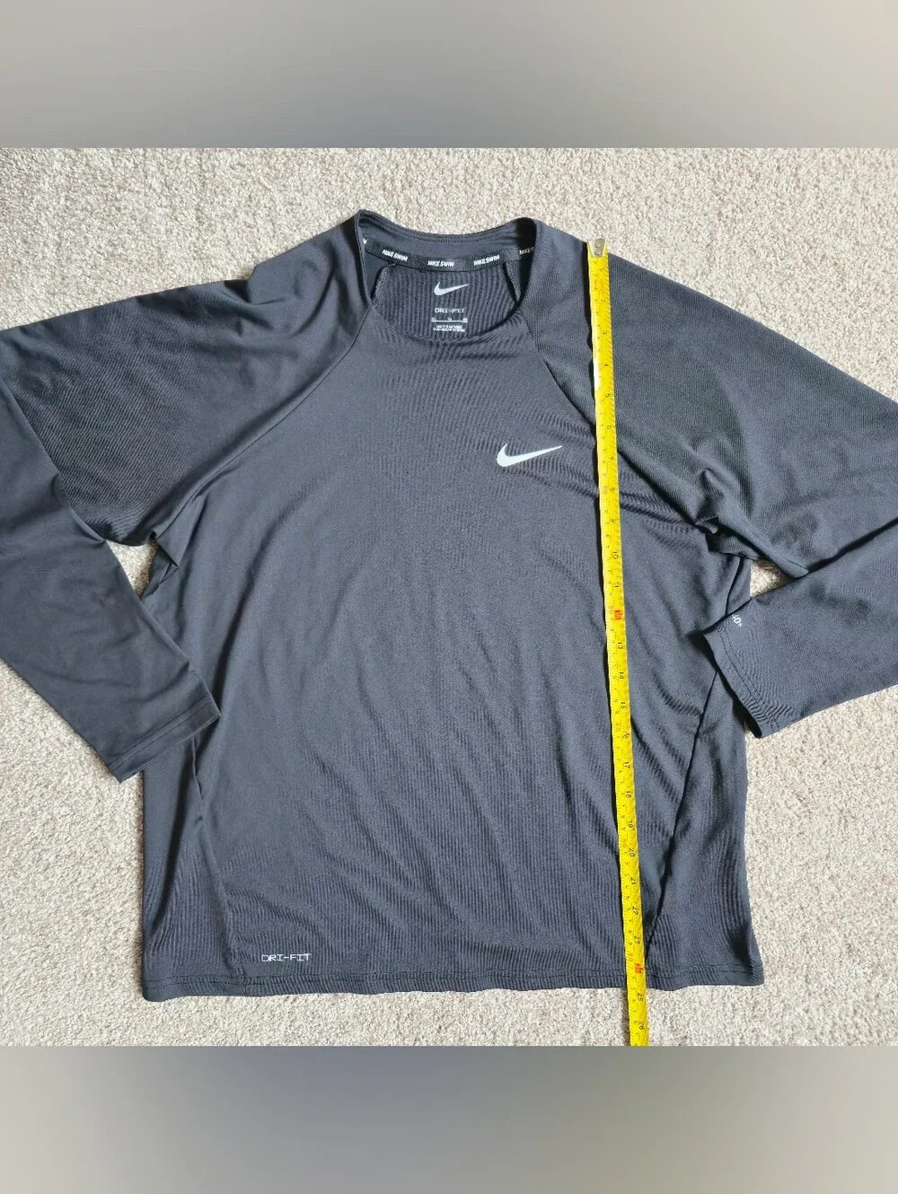 Nike Swim Dri-FIT long-sleeve Rashguard features a classic athletic crewneck